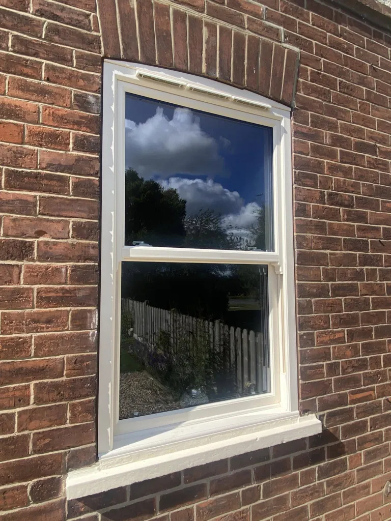 Cream sash horn windows with decorative glazing bars installed on the property