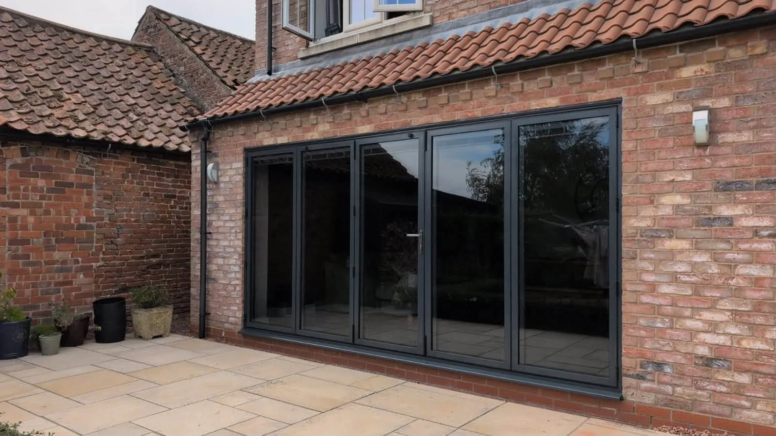 New Anthracite Grey 5-panel Cortizo aluminium bifold doors in the same opening