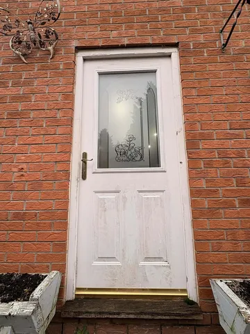 Weathered white composite side door before replacement