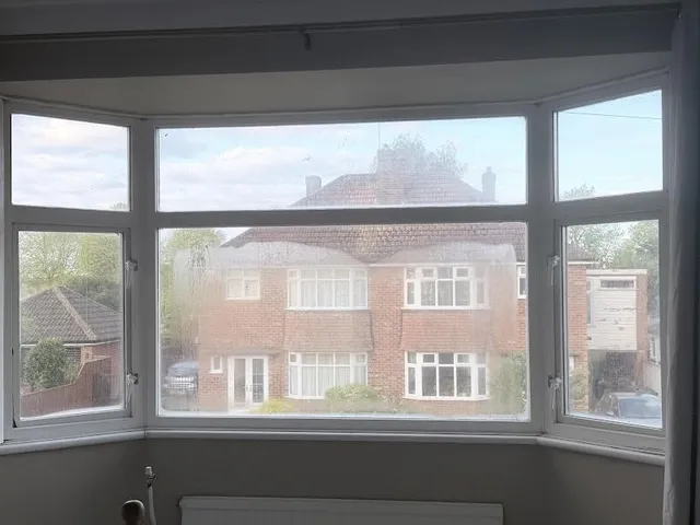 Bay window with severely blown double glazing, the glass permanently misted and foggy